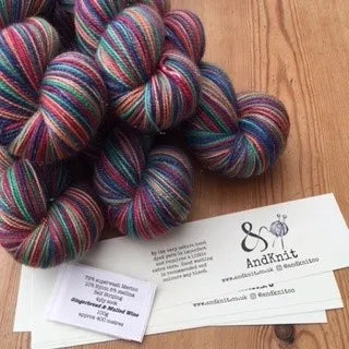 a group of yarn balls next to business cards